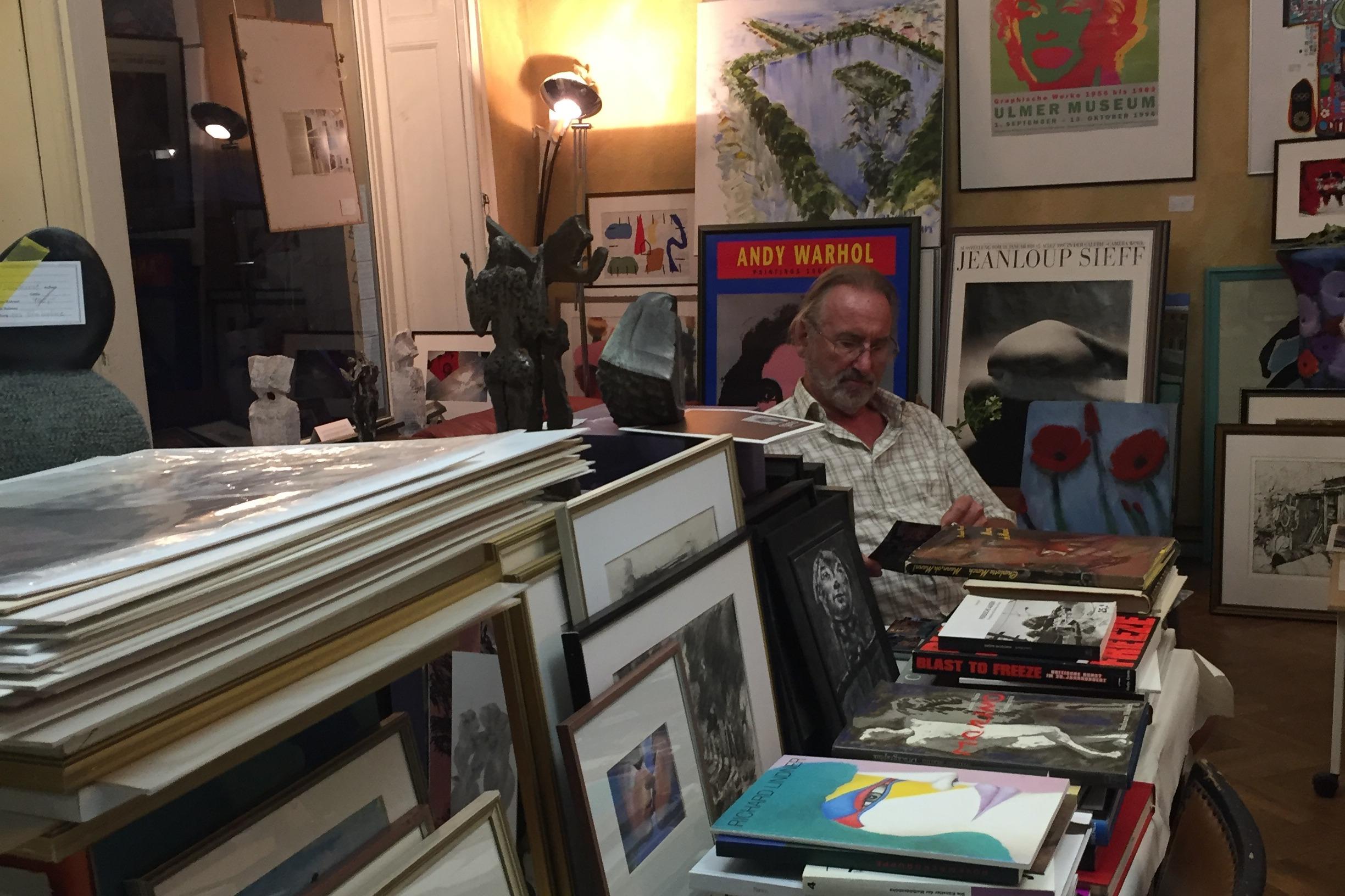 A photo of a man sat in a shop